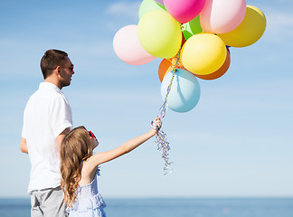 Image showing father and daughter with colorful balloons