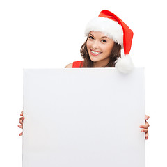 Image showing woman in santa helper hat with blank white board