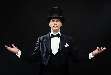 Image showing magician in top hat showing trick