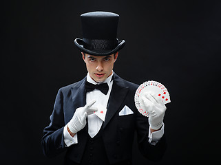 Image showing magician showing trick with playing cards