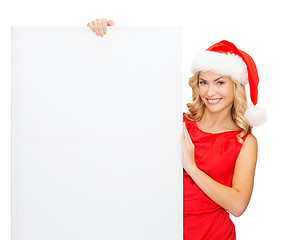 Image showing woman in santa helper hat with blank white board