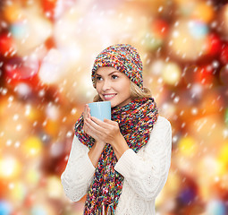 Image showing woman in hat with red tea or coffee mug