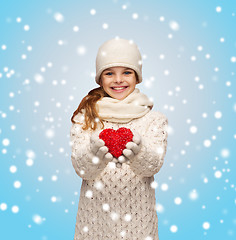 Image showing girl in winter clothes with small red heart