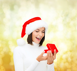 Image showing surprised woman in santa helper hat with gift box