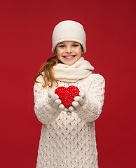 Image showing girl in winter clothes with small red heart