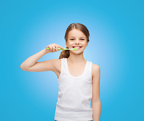 Image showing girl in blank white shirt brushing her teeth