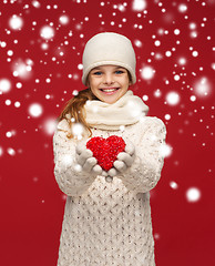 Image showing girl in winter clothes with small red heart