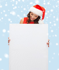 Image showing woman in santa helper hat with blank white board