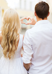 Image showing romantic couple in the city making heart shape