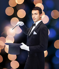 Image showing magician in top hat with magic wand showing trick