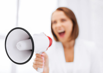 Image showing strict businesswoman shouting in megaphone