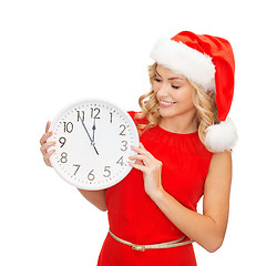 Image showing woman in santa helper hat with clock showing 12