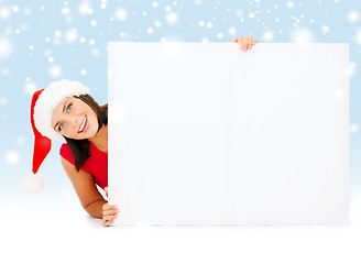 Image showing woman in santa helper hat with blank white board