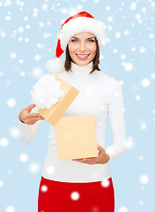 Image showing smiling woman in santa helper hat with gift box