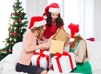 Image showing women in santa helper hats with many gift boxes