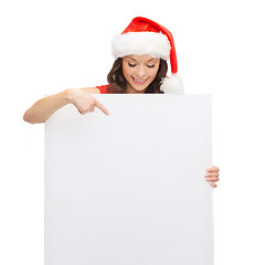 Image showing woman in santa helper hat with blank white board