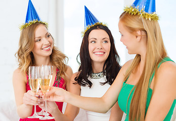 Image showing three women wearing hats with champagne glasses