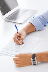 Image showing man signing a contract