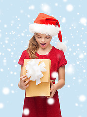 Image showing smiling girl in santa helper hat with gift box