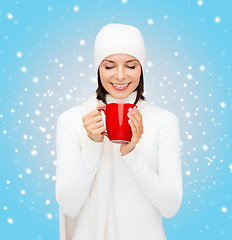 Image showing woman in hat with red tea or coffee mug