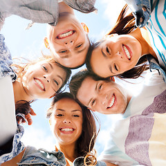 Image showing group of teenagers looking down