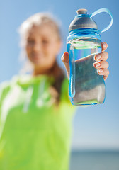 Image showing woman showing a bottle of water