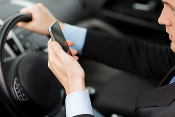 Image showing man using phone while driving the car