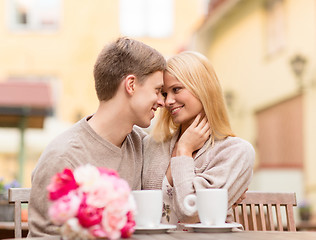 Image showing romantic happy couple kissing in the cafe