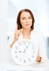 Image showing attractive businesswoman with white clock