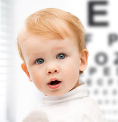 Image showing adorable baby child with eyesight testing board