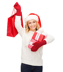 Image showing woman in santa helper hat with shopping bags