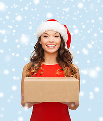 Image showing smiling woman in santa helper hat with parcel box