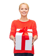 Image showing smiling woman in red sweater with gift box