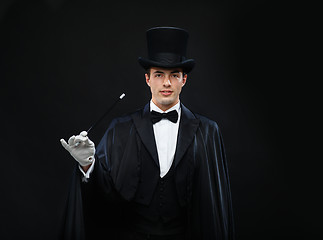 Image showing magician in top hat with magic wand showing trick