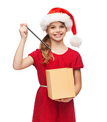 Image showing smiling girl in santa helper hat with gift box