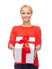 Image showing smiling woman in red sweater with gift box