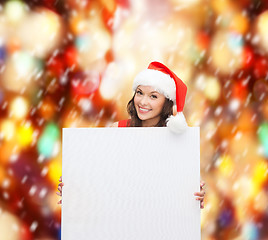 Image showing woman in santa helper hat with blank white board