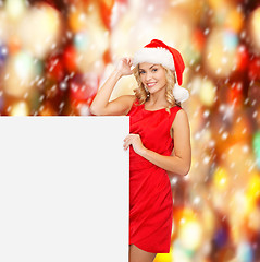 Image showing woman in santa helper hat with blank white board