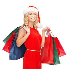 Image showing woman in red dress with shopping bags