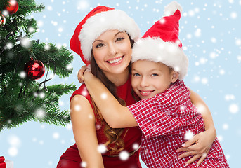 Image showing happy mother and child boy in santa helper hats