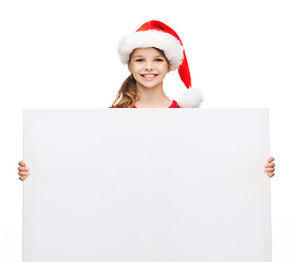 Image showing woman in santa helper hat with blank white board