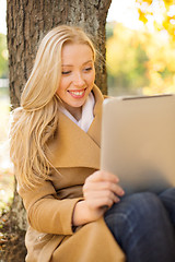 Image showing woman with tablet pc in autumn park