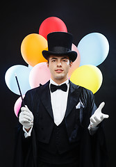 Image showing magician in top hat with magic wand showing trick