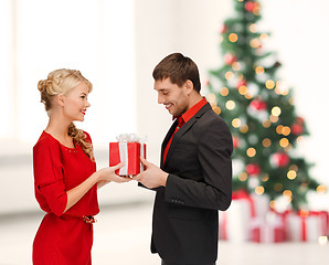 Image showing smiling woman and man with gift box