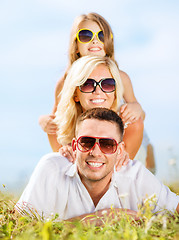 Image showing happy family with blue sky and green grass