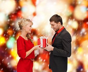 Image showing smiling woman and man with gift box