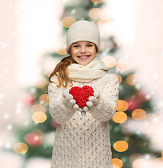 Image showing girl in winter clothes with small red heart