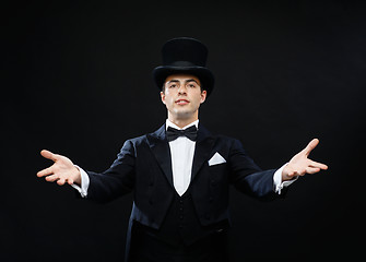 Image showing magician in top hat showing trick