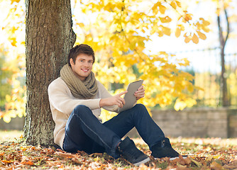 Image showing man with tablet pc in autumn park