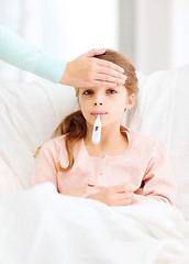 Image showing ill girl child with thermometer and caring mother